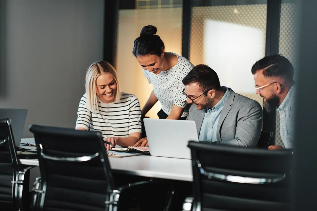 Businesspeople laughing in a boardroom