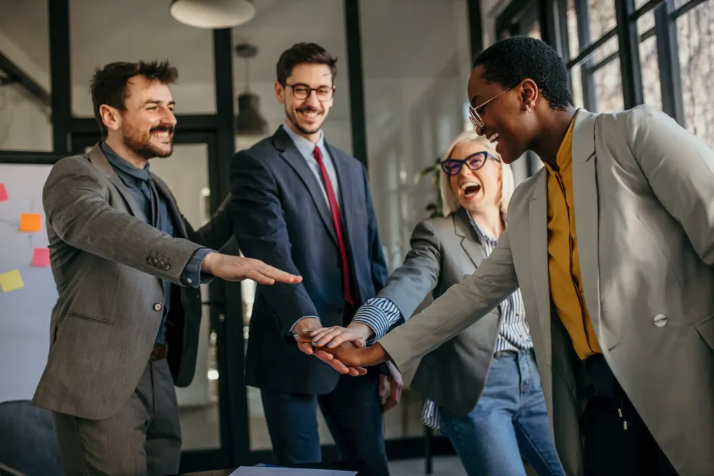 Group of diverse businesspeople holding hands together