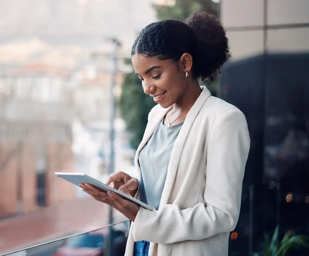 Modern business woman on a tablet during a work break alone outside