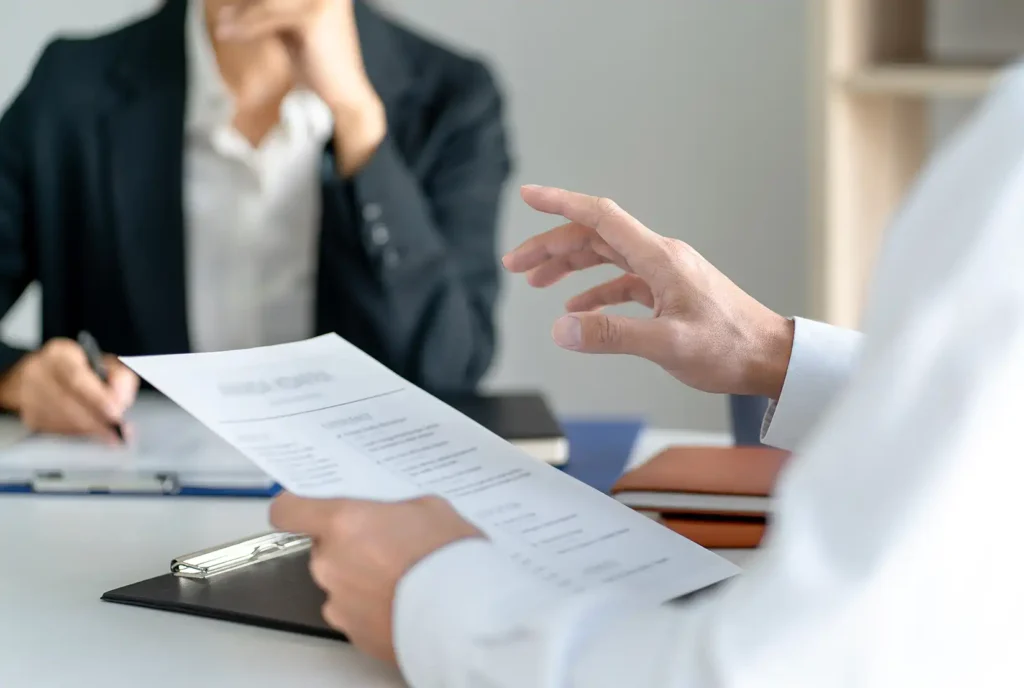 Candidate with resume at job interview with human resource
