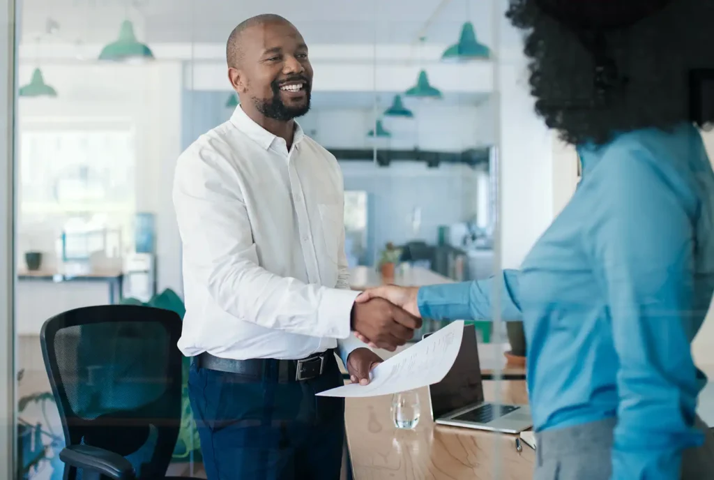 Smiling manager welcoming a new employee