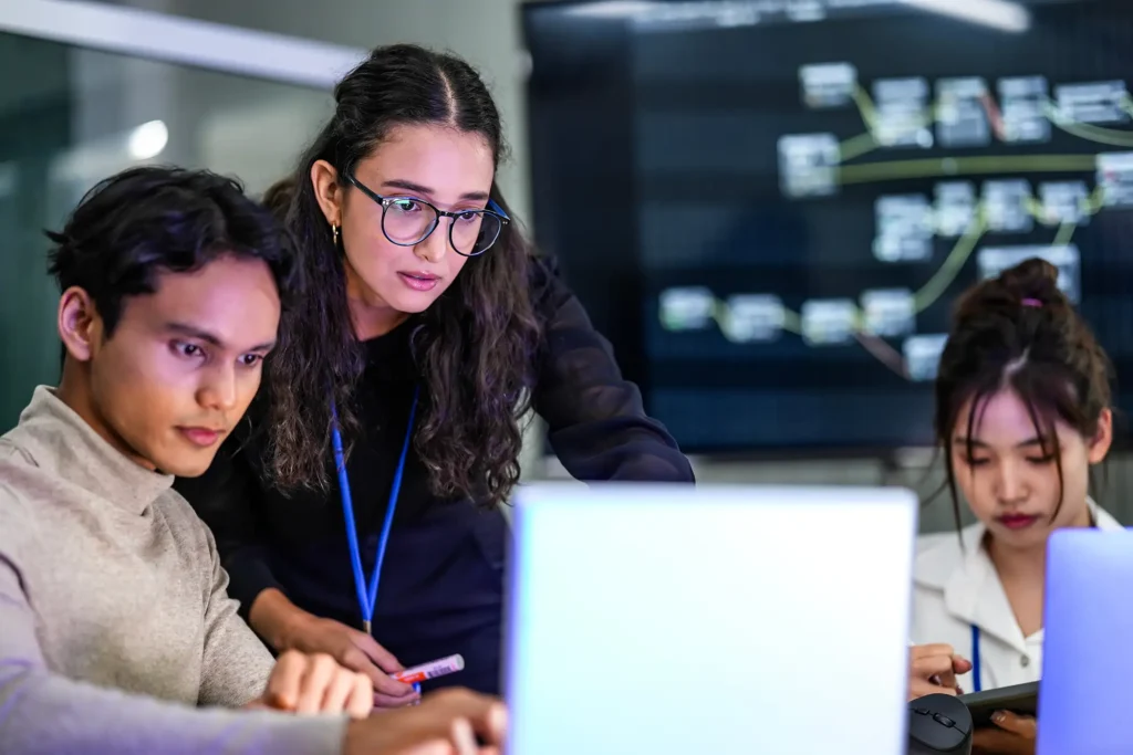 A diverse group of professionals in a corporate workshop on AI development