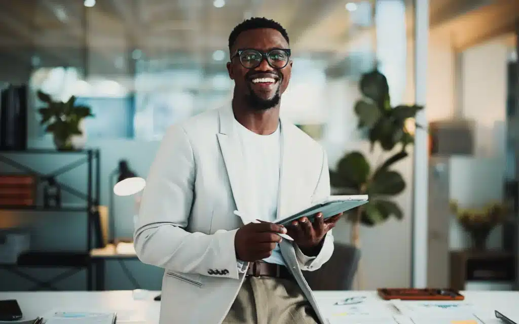 black man in office with tablet, about us or pride in accounting career