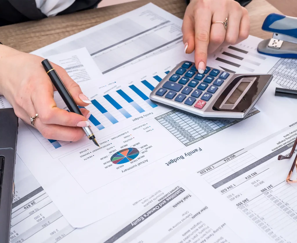 account annual budget with laptop, pen and graph