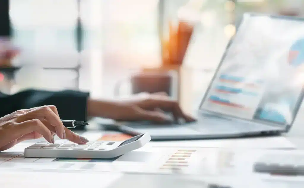 Businesswoman or accountant working Financial investment on calculator